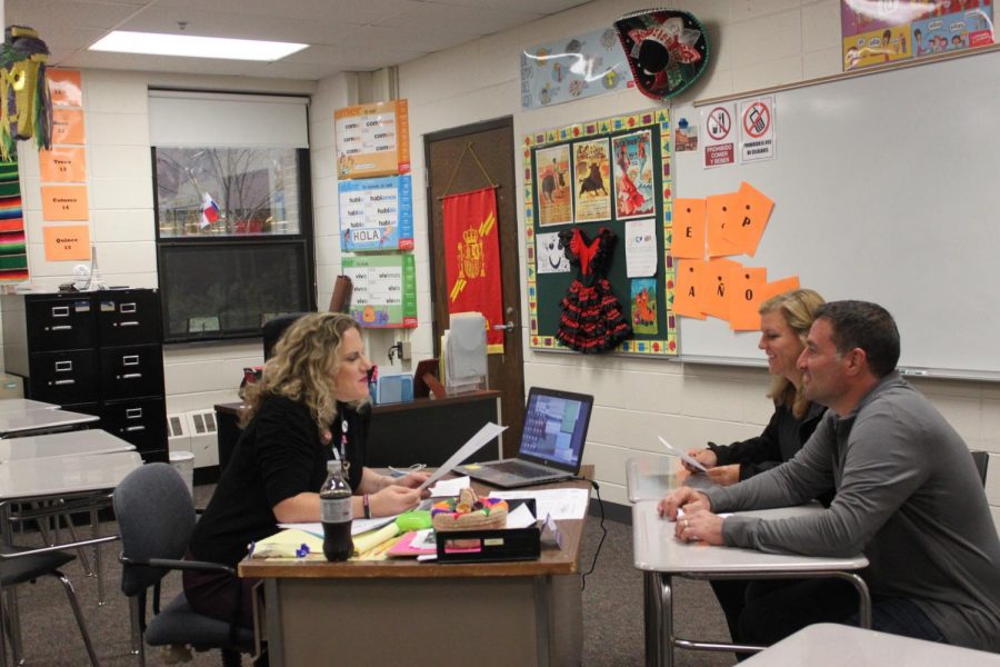 Carlye Hamilton, Spanish teacher, sits down with parents in her class to discuss their students education. 