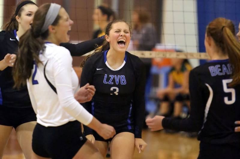 Kylie Dykgraaf and teammate Katie Guy celebrate during a successful volleyball game. Guy supported Dykgraaf throughout her injury and volleyball career.
