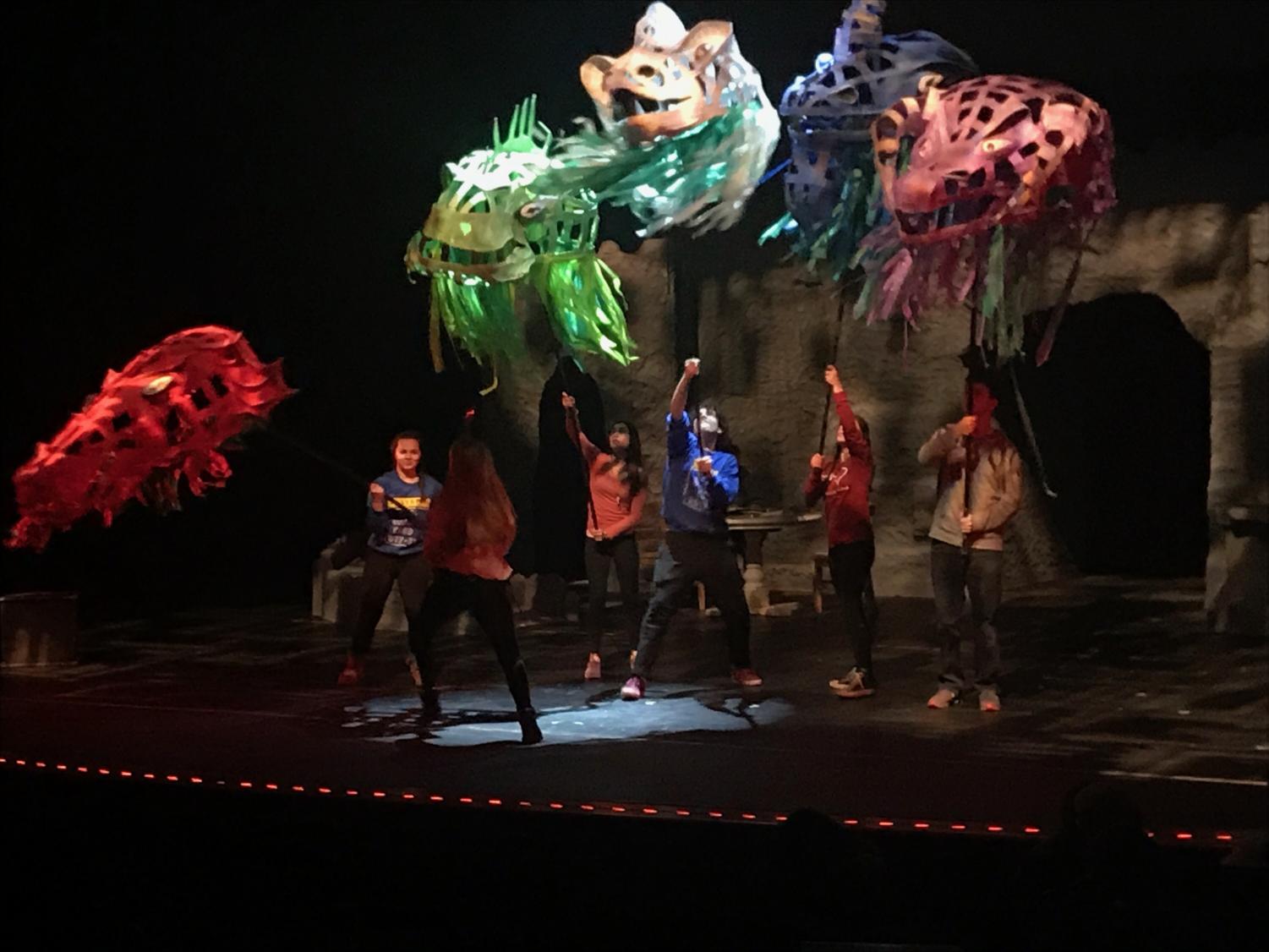 Five of the main characters in the winter play She Kills Monsters, hold up each of the dragon’s head. This is one of the final scenes as Agnes tries to defeat this monster called the Tiamat.