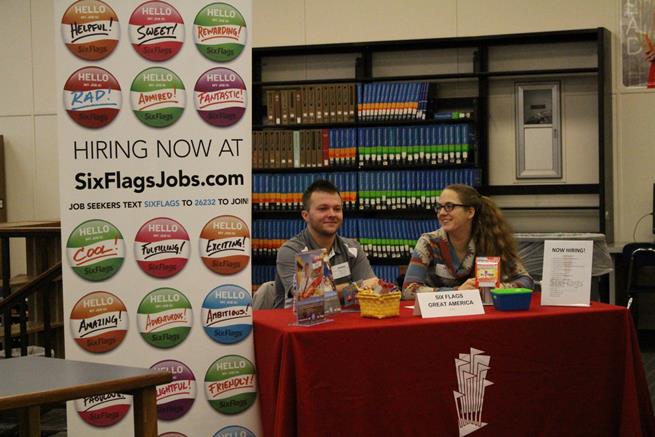 Six Flags employers wait for students to approach their booth during the 2017 job fair. Six Flags is one of the returning buissnesses looking to hire students at this years job fair.