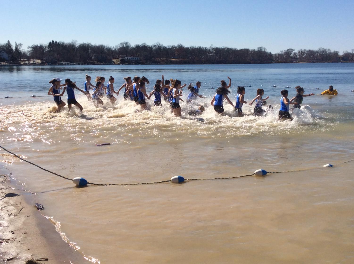 The girls' track and field team participated in the Polar Plunge, among other teams, community groups, and families. The event raised money for families affected by cancer.