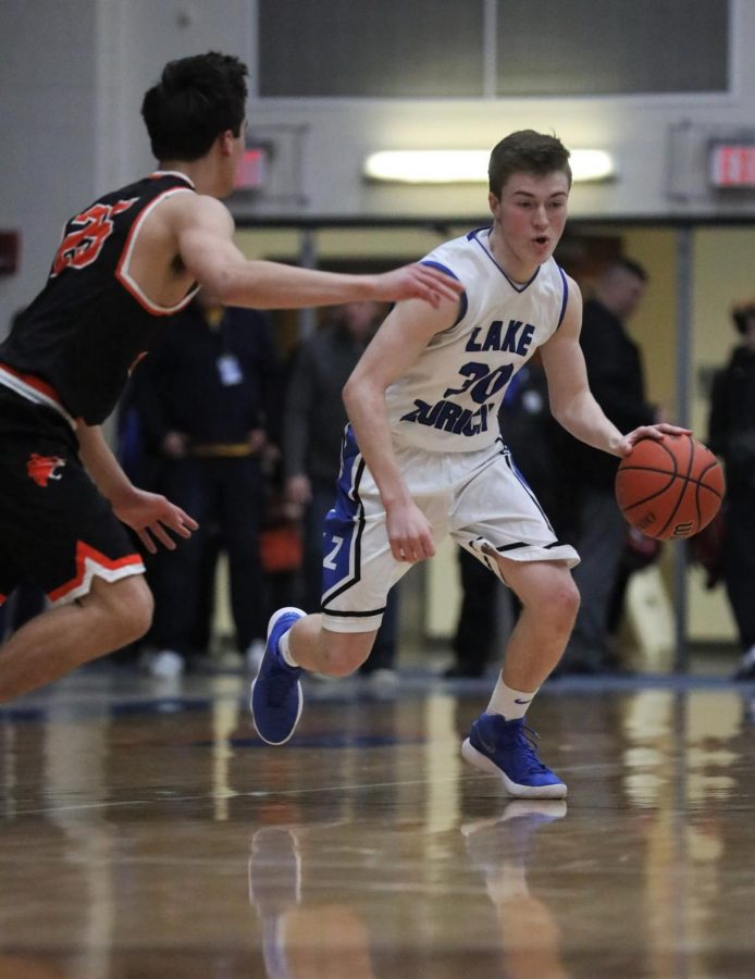 Will Tucker, sophomore, drives into the lane during  a basketball game last season. Tucker hopes that his improvements this offseason will allow him to succeed in a larger team role next season.