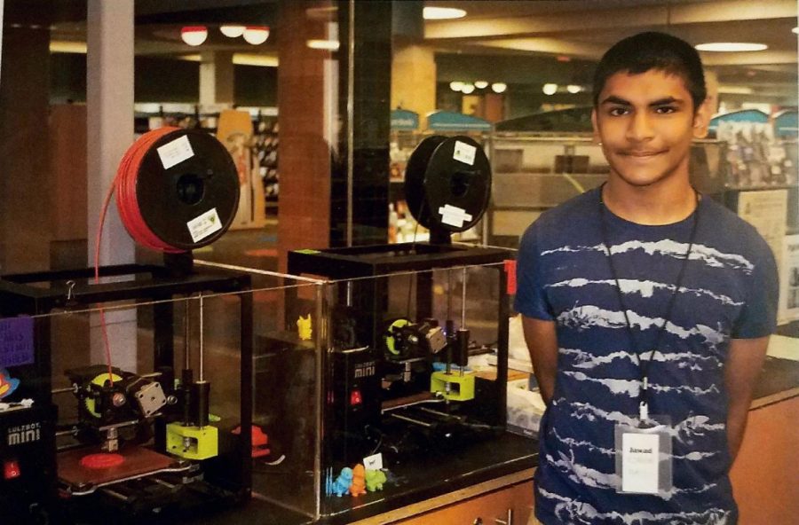 Jawad Alam, sophomore, stands in front of 3D printers at Ela Library. Alam was one of last summer’s interns that the district made available for students.