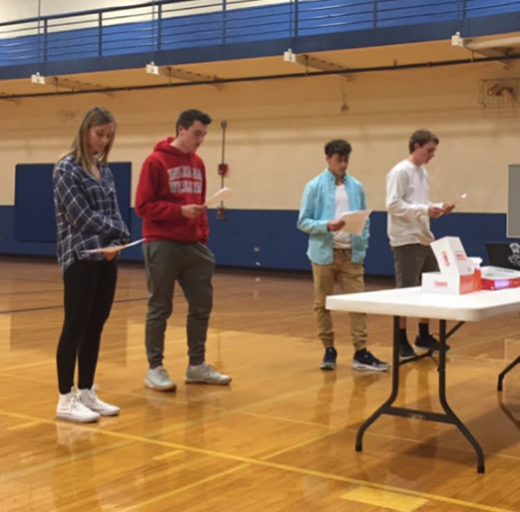 First year leaders (from left) Maddie Schultze, Kyle Schroeder, Shawn Bandel, and Tyler Naughtrip read off of scripts they created at an Fellowship of Christian Athletes (FCA) meeting last year. By working together, this group of leaders helped the new club be successful and continue into its second year at LZHS.