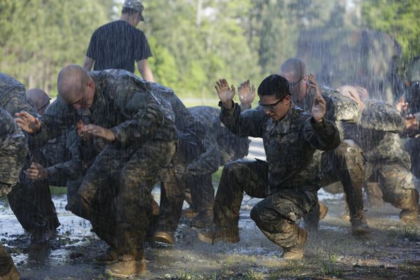 Soldiers training to be military work through the rain to complete their task. This is just some of the intense training Peter Tobin, senior, will have to face through his journey into the marines.