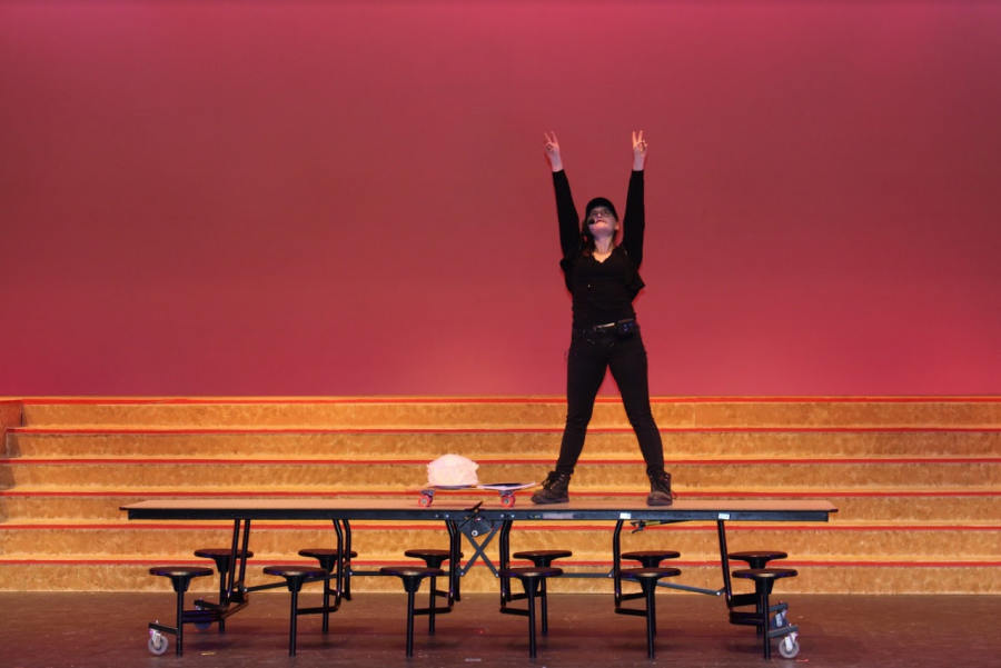 Penny Burke jokes around on stage in the middle of a rehearsal. Burke spent muich of her time in a similar situation throughout high school, dedicating 1800 hours of her time to theatre.