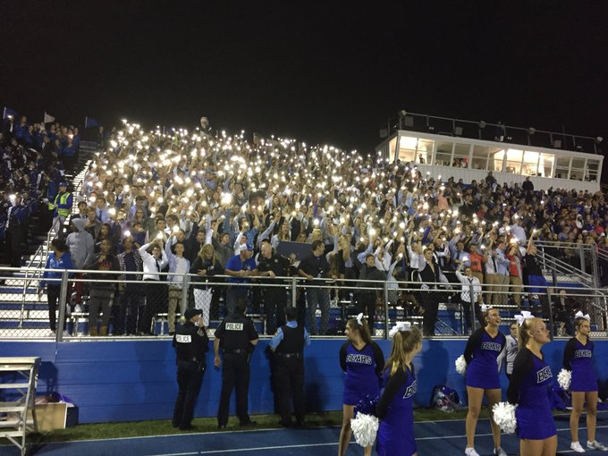 The+student+section+puts+the+light+in+Friday+Night+Lights+during+the+August+24+football+game+against+Fremd.+The+Bear+Den+cheered+the+team+onto+a+20-7+victory.+