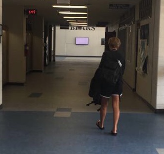 A faculty member uses the new flooring to get to the field house. Many school attendees say they are excited about using these new floors.