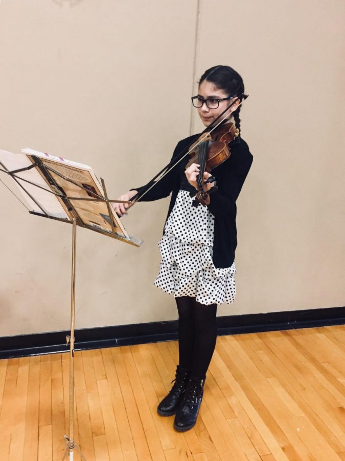 Maka warms up on the violin for a performance at solo and ensemble. This competition is just one of many she participates in to better herself as a musician. 