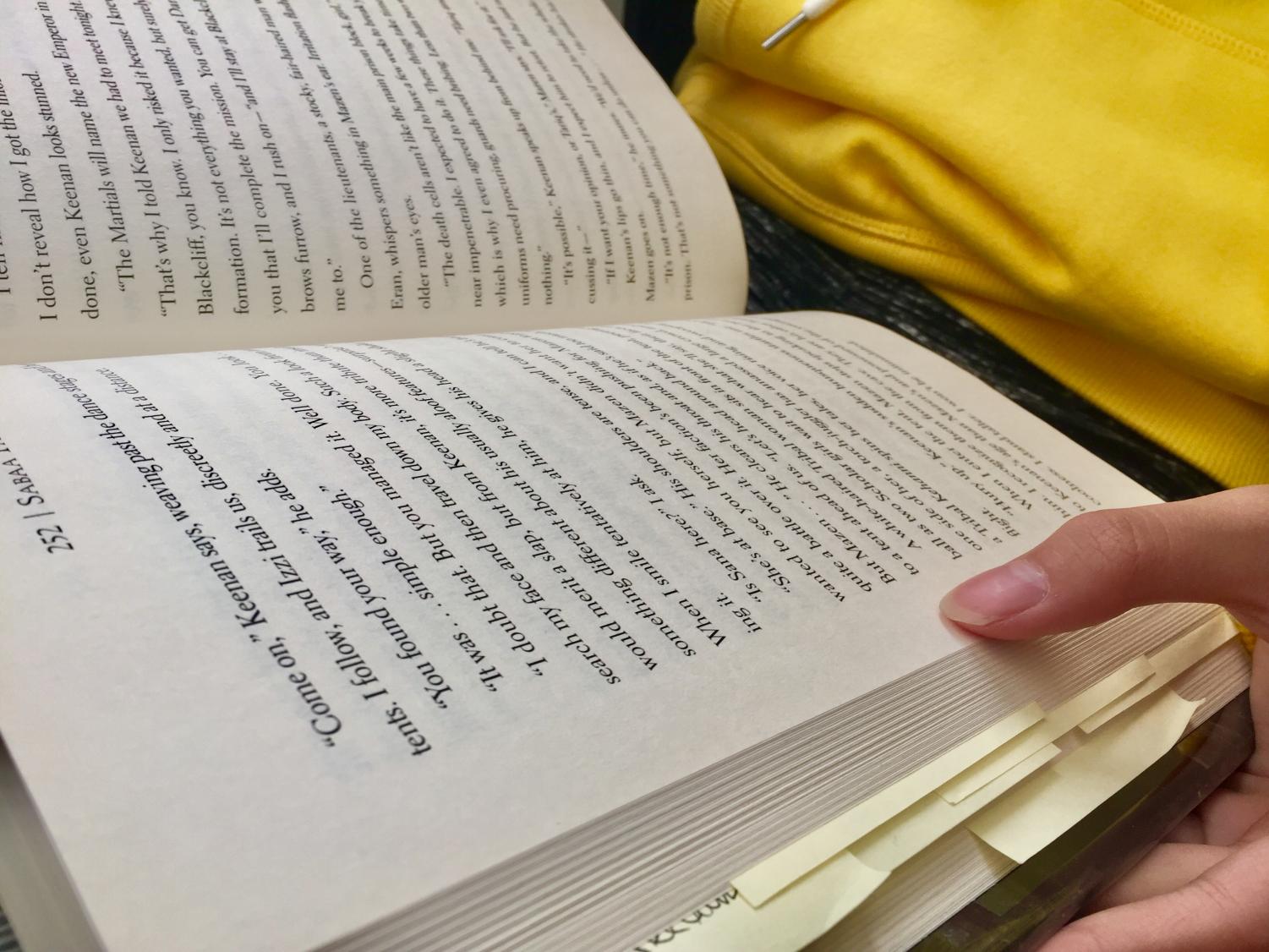 A student enjoys their time by reading a book, not for class but for fun. This activity is exactly what Pine's lunchtime book club will aim to promote.