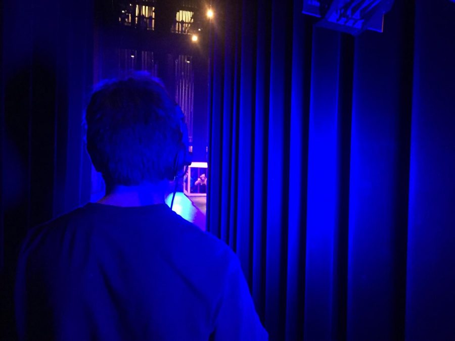 A technician looks on to the stage during a November 8 performance of Seussical. Technicians have been working since September and have been staying late after school in order to make the show a success.