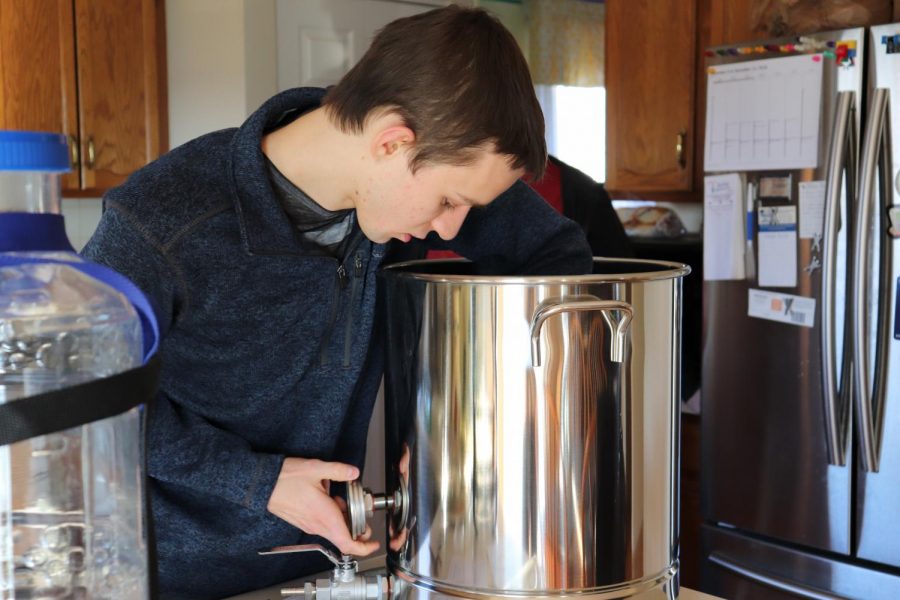 Ryan Pearce, senior, works on putting together new equipment for home brewing. For years, this hobby has been a passion of his, so much that he hopes to make it his career.