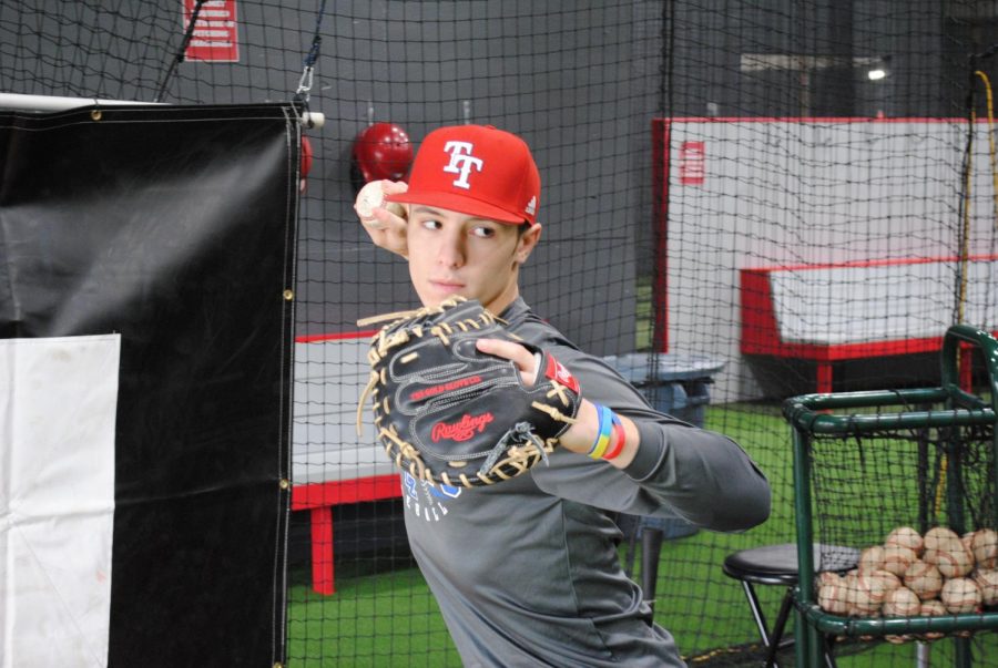 Tyler Snep, senior, gears up to practice throwing the ball down to second from home plate. Sneps pop time, or the time from when the pitch hits his glove to when it is thrown down to second base, is  1.96-2.01 seconds