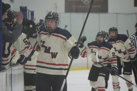 Players on the hockey team celebrate after a goal during a 4-3 shootout loss to Evanston on February 21. The team now is in the State Tournament and will play Wheaton on Sunday in the Sweet Sixteen