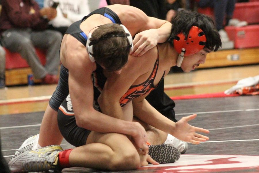 Ian McGee, senior, attempts to take down an opponent at Regionals on February 9. McGee placed third in the 113 weight class and will be advancing to State next weekend.