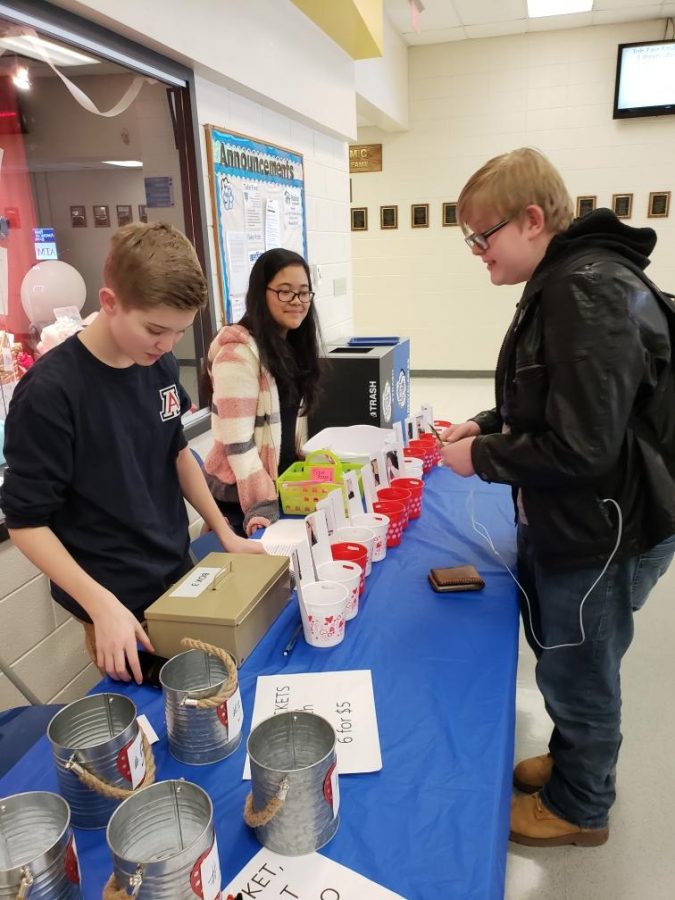 Alex Ketcham, Sports Writer, and Mealea Khek, journalism 2 student, help sell raffle tickets. The raffle was just one of the many fundraisers hosted by Bear Facts to raise awareness for free speech.