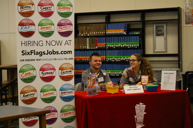 Six Flags employers wait for students to approach their booth during the 2017 job fair. Six Flags is one of the returning buissnesses looking to hire students at this years job fair.