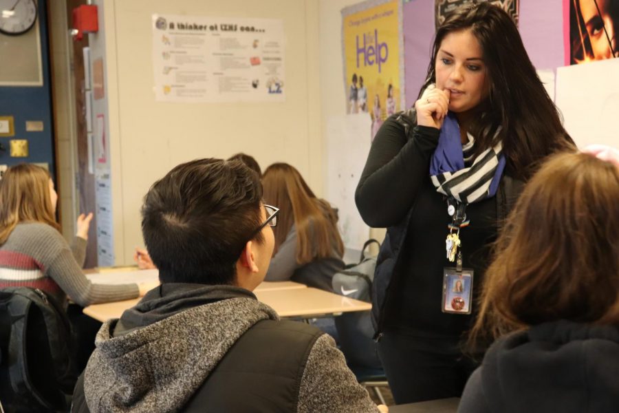 Kim Philipp, English teacher, talks with students about a class project. The most concern [about the walls] Ive ever seen [from students] was when the lockdown took place, Philipp said. Just because it was this classroom.