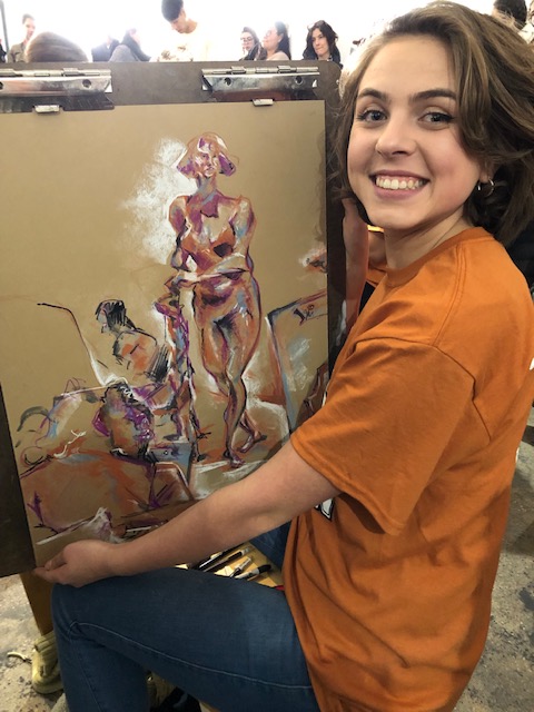 McKenna Kalesz, sophomore, showcases her live model drawing from the Chicago art exhibition. Her drawing won first place in the art throw down.