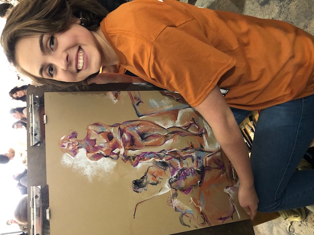 McKenna Kalesz, Junior, showcases her live model drawing. Her drawing won first place in the art throw down