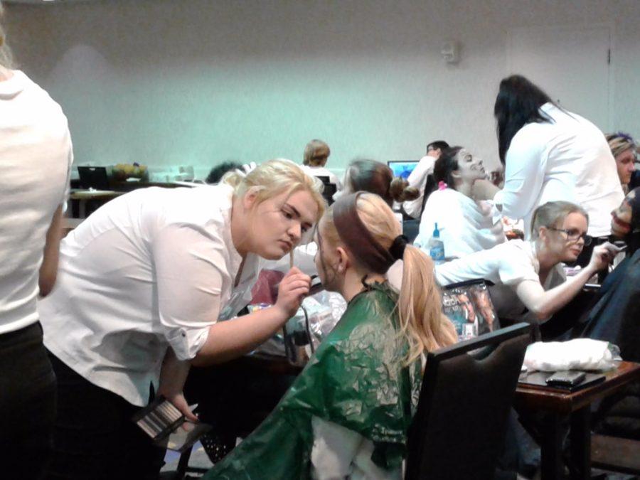 Cosmetologists work on their models makeup at Skills USA. Caroline Clouse, junior, who participated in this event,. said that it was very interesting to see what other artists were doing, and that one of the participants drew a spider that looked like it was alive.