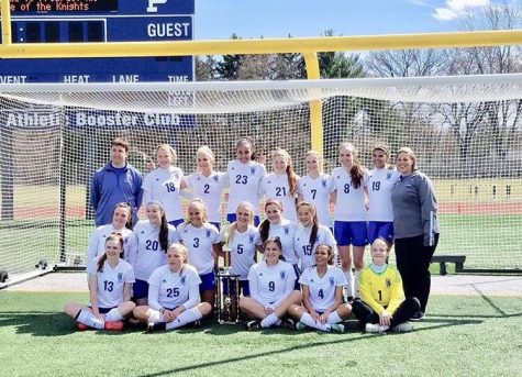 The girls soccer team poses with the trophy after winning the Prospect Tournament on Sunday. The team went 4-0 in the tournament to capture the title.
