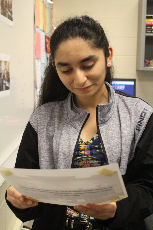 Yusra Zakria holds an old photo. Zakria says that reflecting on her negative experiences has helped her make decisions for the future.