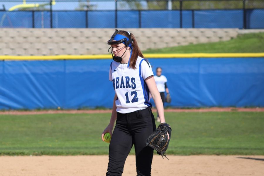 Maura Ginn, sophomore, stares down towards the plate and prepares to pitch during a May 13 game against Mundelein. Sad the teams season ended this past week, but the team will now look ahead to next year. 