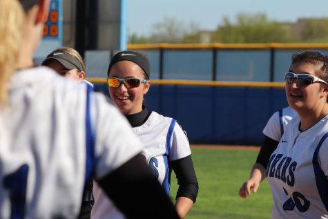 Nina Kolb, sophomore varsity softball player, cheers on a teammate during a game. Players such as Kolb work hard to help the Softball program gain fans and recruits, but feel as if the program is often overlooked.