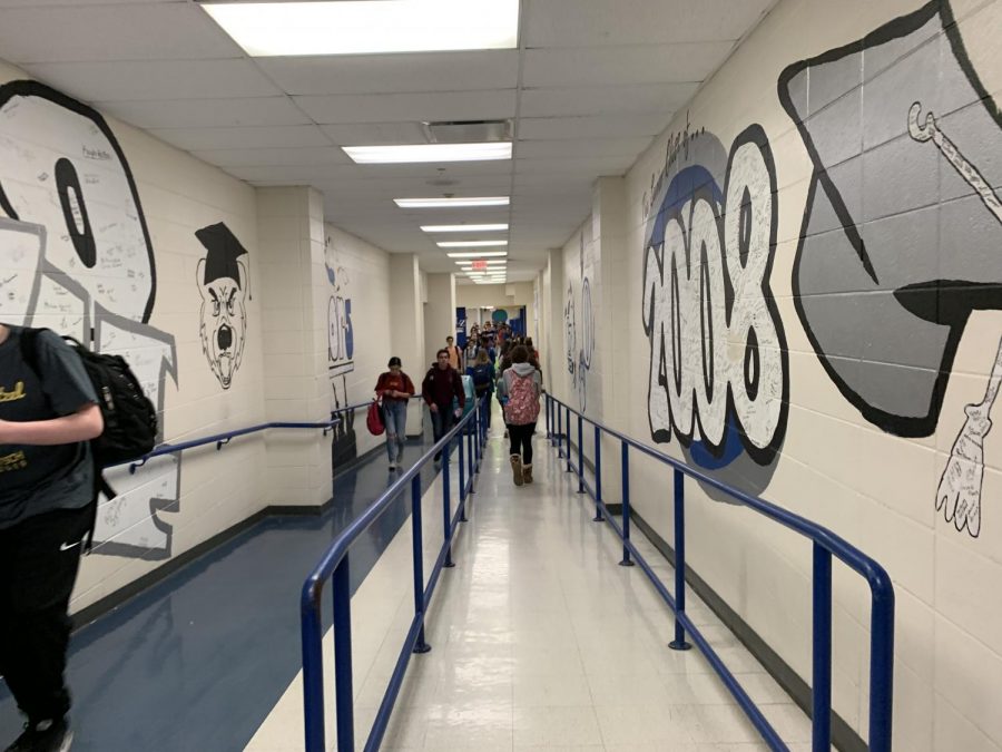 Students+walk+through+the+hallways+of+murals+with+signatures+of+past+seniors.+Kelly+Bush%2C+Senior%2C+sudjects+that+if+the+school+gives+students+prodjects+to+decorate+a+certain+area+of+the+school%2C+this+could+show+representation+and+liven+up+the+walls+of+the+school.+