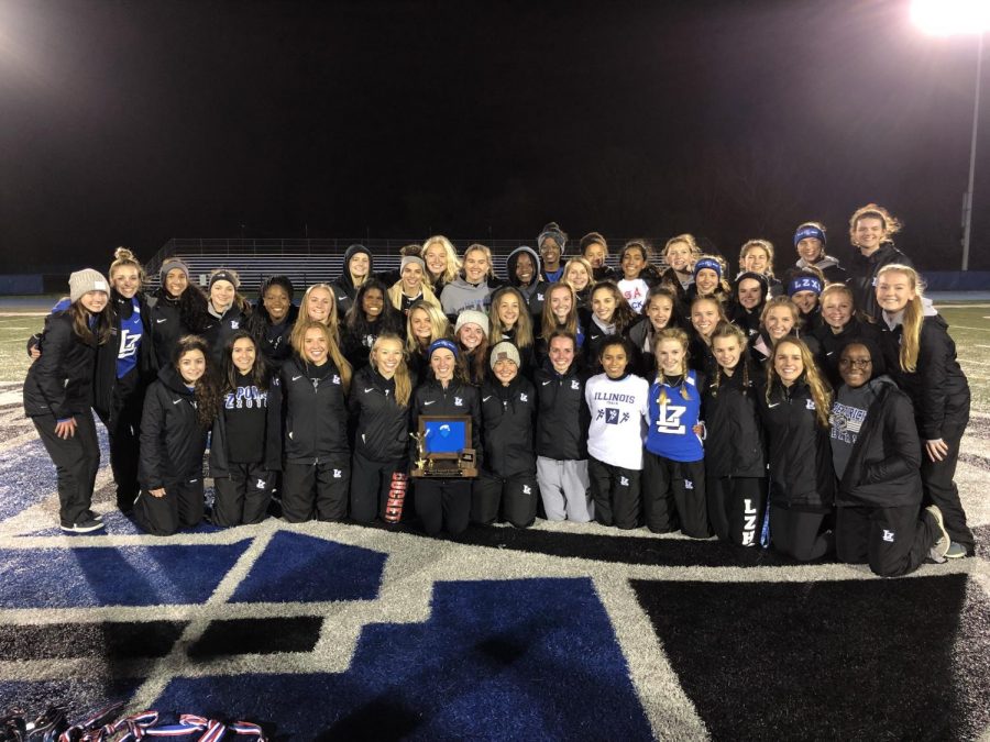 The girls track and field team poses with their NSC Championship trophy on Thursday at home. This is the teams second consecutive conference title.