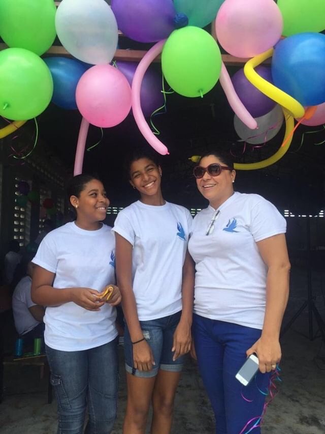 Gia Antoine, senior, standing with her aunt and cousin, who started a foundation for kids with mental and physical disabilities. At events like these, Antoine was able to help out those in Haiti through her volunteer work. 