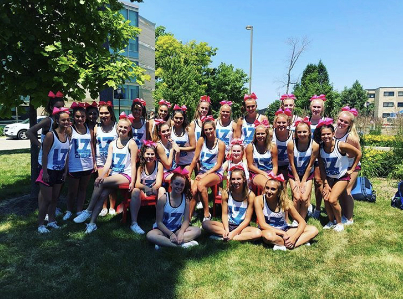 The 2018-2019 Varsity cheer team poses for a picture before their first day of Nation Cheer Association Speed Camp. “I feel like since we have to pay so much for the good instructors, it can really get you to work your butt off [and utilize what you’re getting]. You get so much done at those camps because the instructors are trained well so they know how to keep us going and motivated,” Davison said.