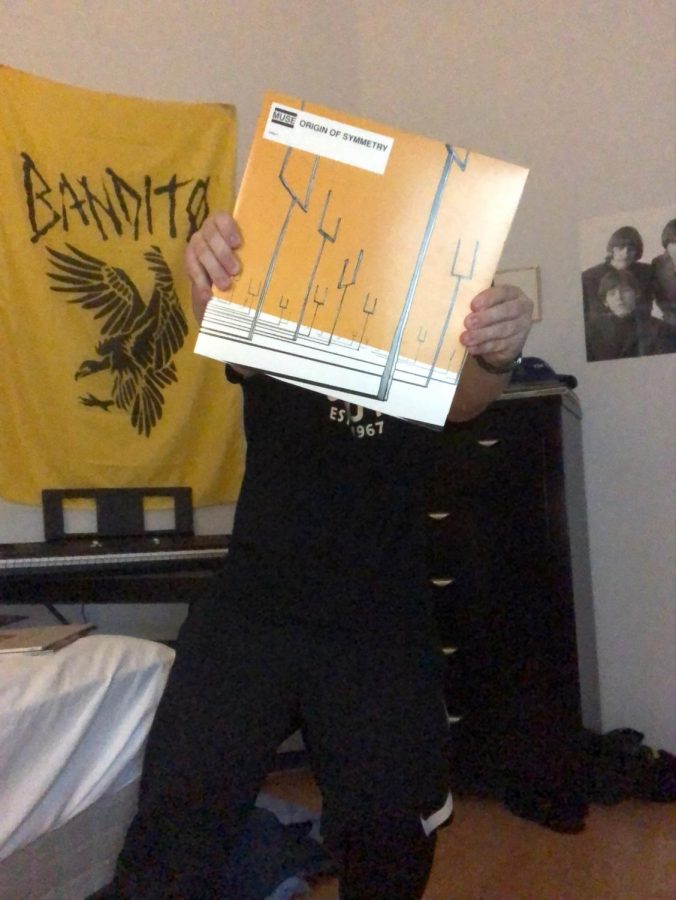 Daniel Chechelnitskiy, sophomore poses with his copy of Origin of Symmetry by Muse, a pop punk band.
