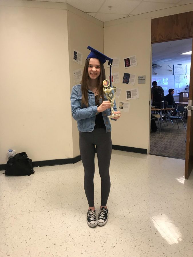 Kelly Bush, senior, holds a 1st place trophy. Bush who used to compete in Irish dance competitions, or feises, frequently won.