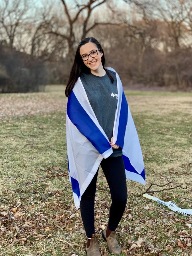 Elana Redfern, senior, poses with an Israeli flag. Next year, rather than going immediately to college, Redfern will spend nine months in Israel to learn the culture and help out in less developed areas.