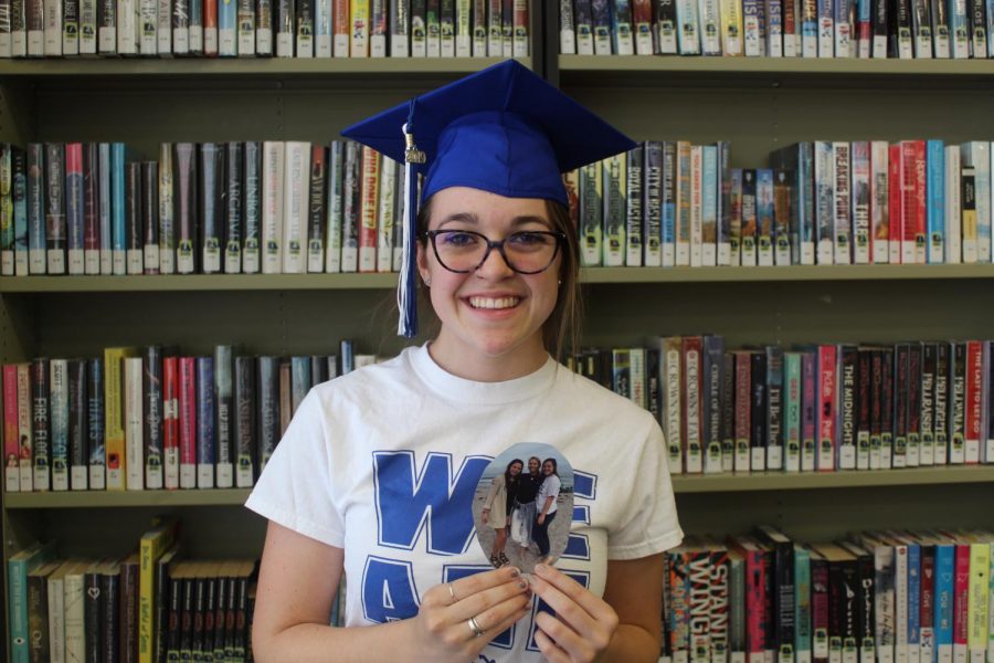 Torrey smiles fondly with a picture of her mom. Despite everything that has happened she is still  in high spirits for graduation.