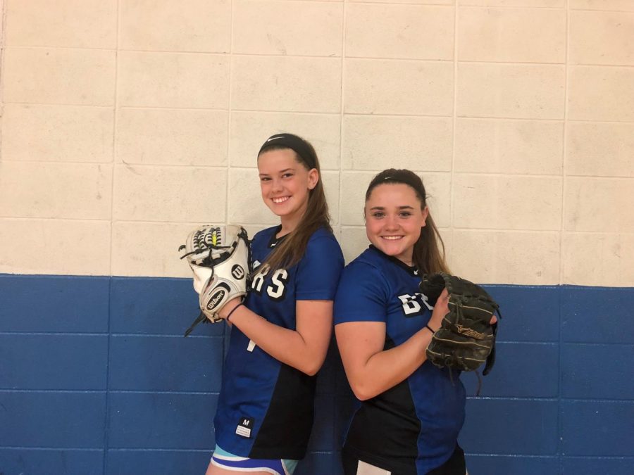 Seniors and best friends, Haley Gajewski and Julia Zaucha, pose for a photo in their softball gear. The two girls have been teammates since middle school.