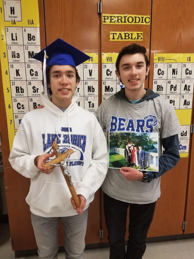 Chad Oliver, left, holds a cross showing his religious faith. His brother; Sean Oliver, right holds a picture of their family together.