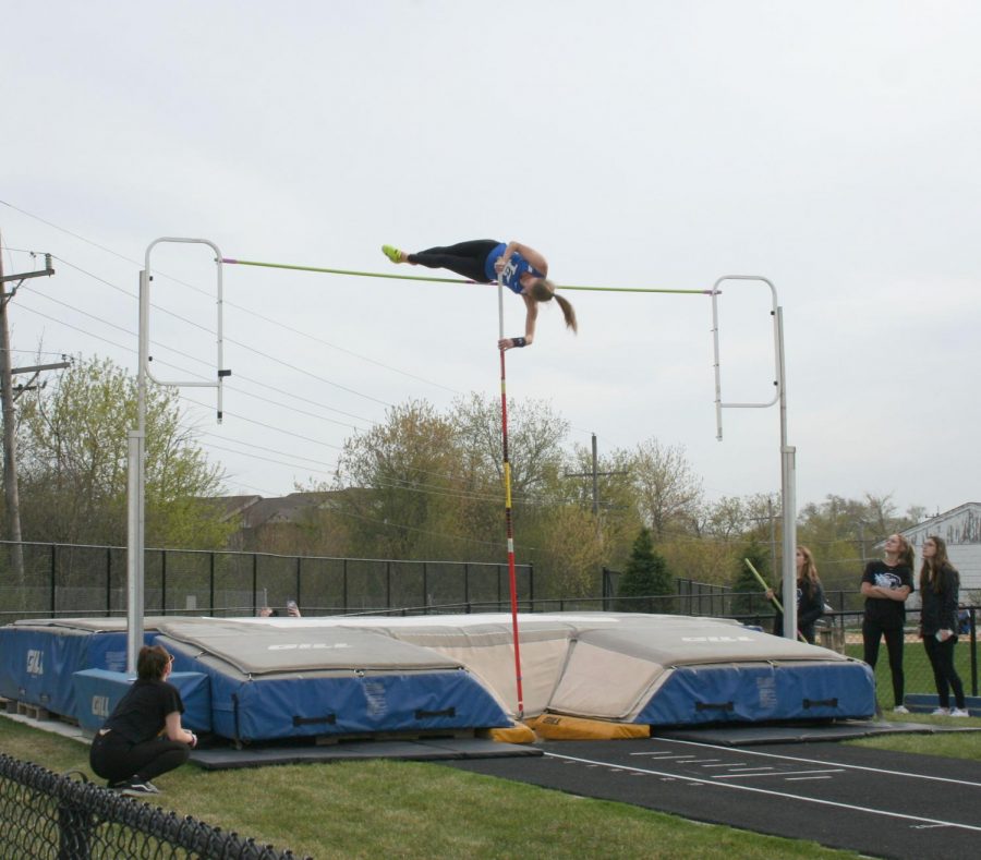 Kelsey Rothas, junior, clears the bar in pole vault at the Lake County Invite on Thursday. Rothas ended up winning the event.