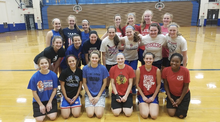 The basketball team poses for a picture during their annual summer camp. The athletes work four days a week to improve individually and as a team.