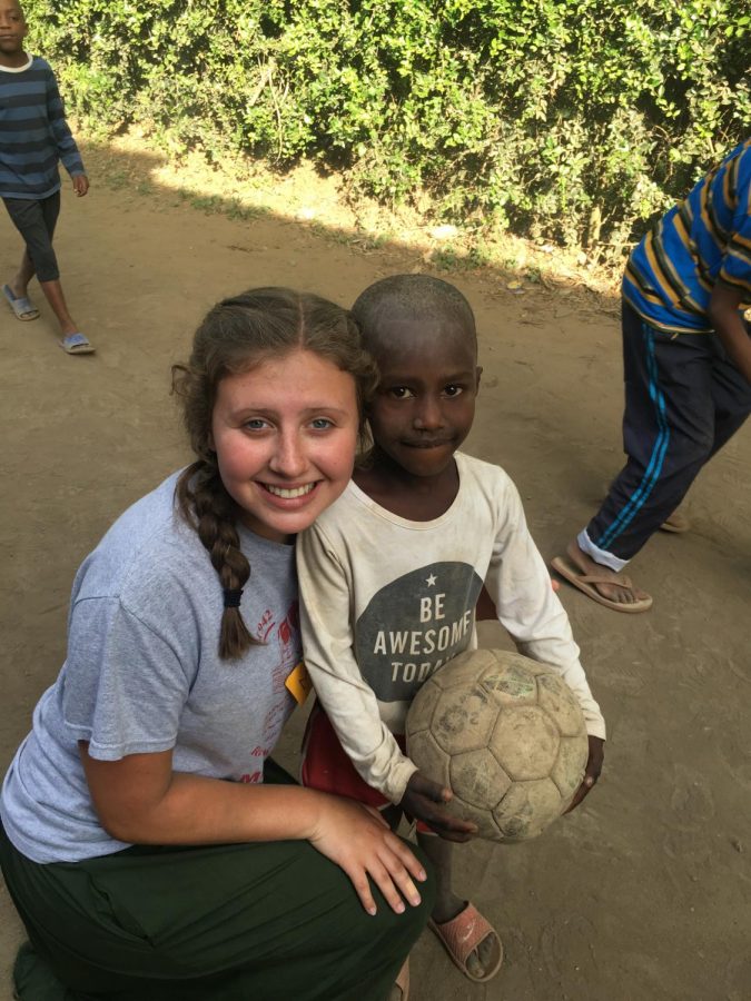 Maya+Wiley%2C+senior%2C+smiles+with+one+of+the+kids+from+Africa%2C+after+playing+soccer.+Wiley+not+only+played+with+the+kids%2C+but+she+also+helped+improve+their+schools.