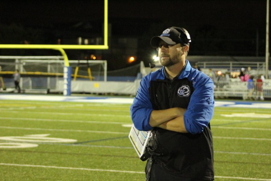 Ron Planz, varsity football coach, watches his players from the sideline.  Although most of his prior football coaching experience was with college players, he says that the knowledge he gained then is invaluable in working with the LZ team. 