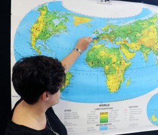 Laura Kustra, world history teacher is seen pointing at Europe. The curriculum was Eurocentric but the school is moving towards a more inclusive curriculum, according to Kustra.