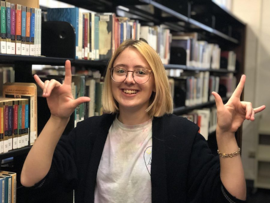 Cassidy Cwiertnia, senior, makes the gesture for love in ASL. For her, sign language is not just a hobby, but a passion that she hopes to pursue in the future. 