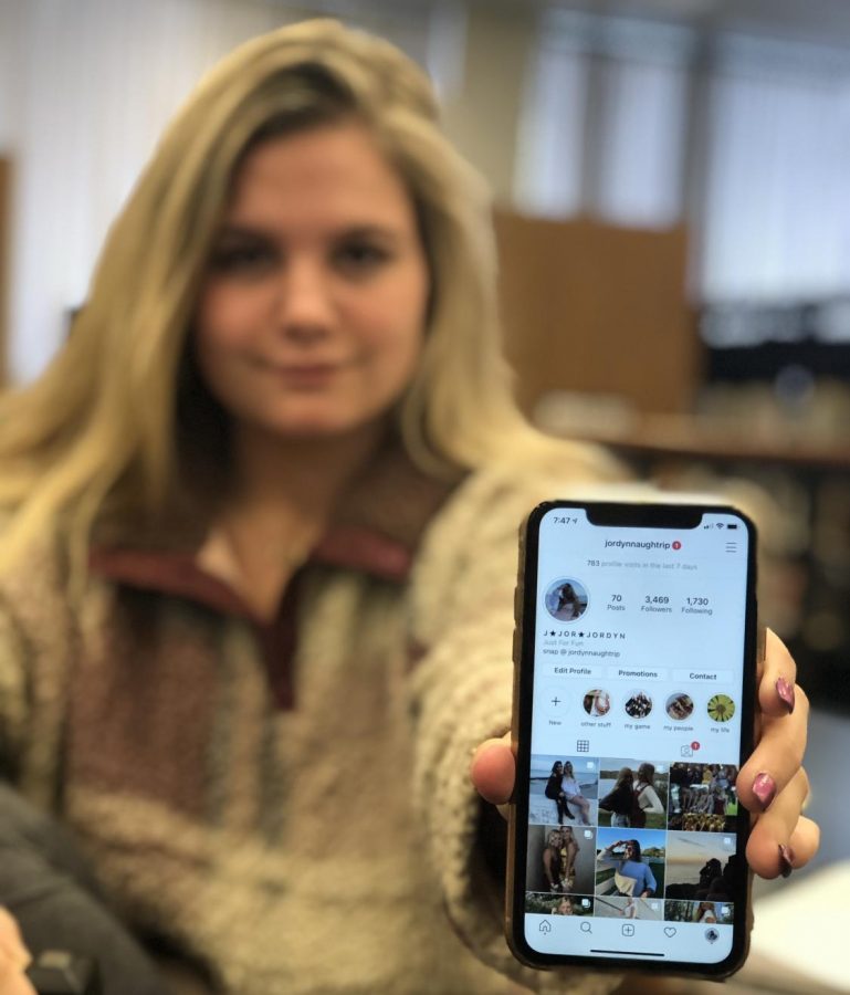 Jordyn Naughtrip, junior, holds up her Instagram account (@jordynnaughtrip). She hopes to use her Instagram platform to encourage others to be themselves. 