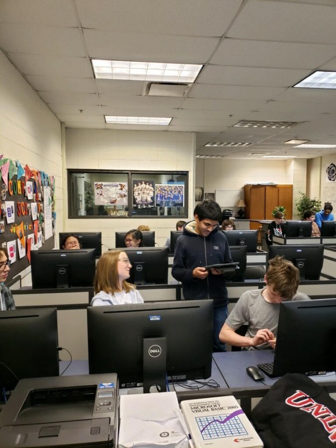 Jawad Alam, leader of Hack club, helping members of the club. Hack club is a very laid back club, where members are expected to learn at their own pace.