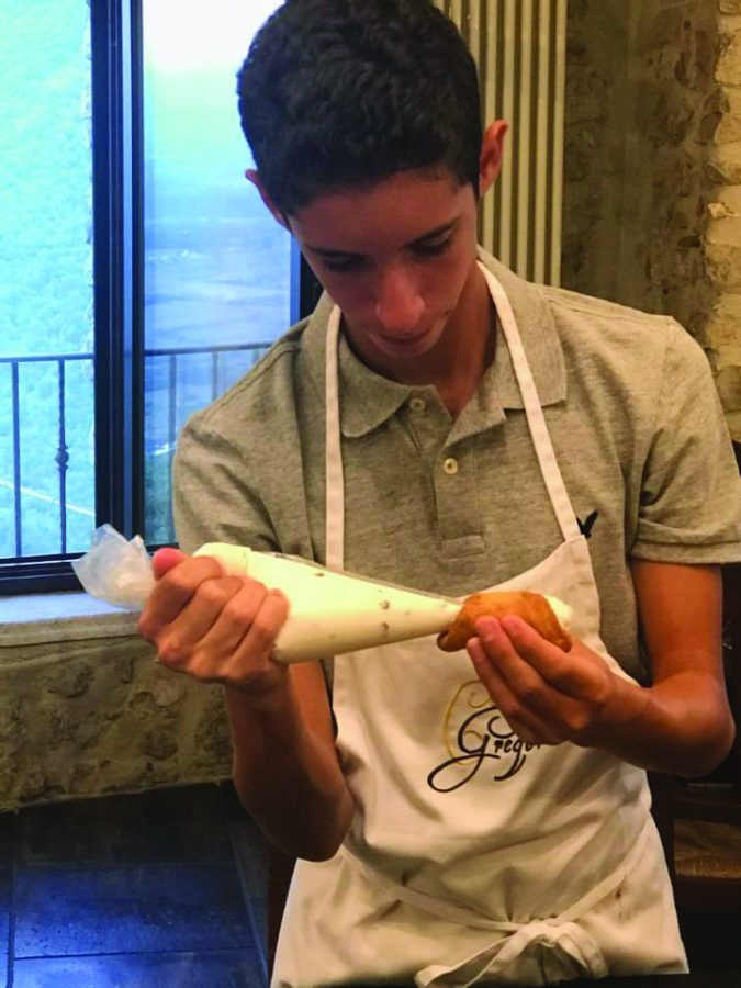 Elliot Finn, sophomore, celebrates Hanukkah and says his favorite part of the holiday is making cookies and spending time with family. Here he practices his cookie craft during a baking class. 