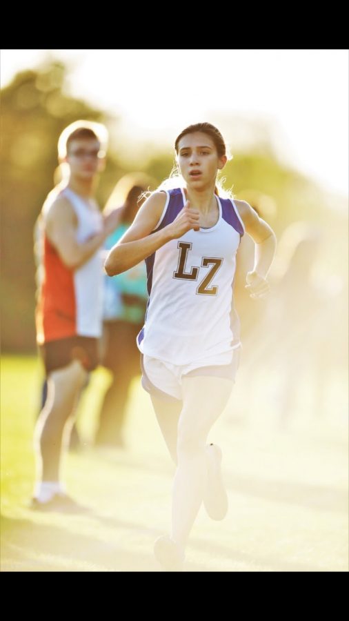 Brooke Johnston, freshman, races towards the finish line. Johnston loves to run and with her fast times, she was able to compete in State as a freshman.