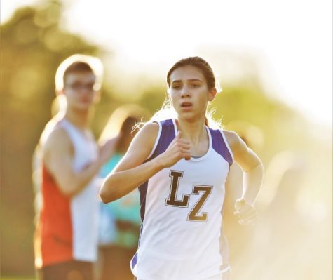 Brooke Johnston, freshman, races towards the finish line. Johnston loves to run and with her fast times, she was able to compete in State as a freshman.